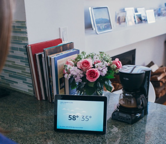 An Echo Show on the kitchen counter displaying the weather