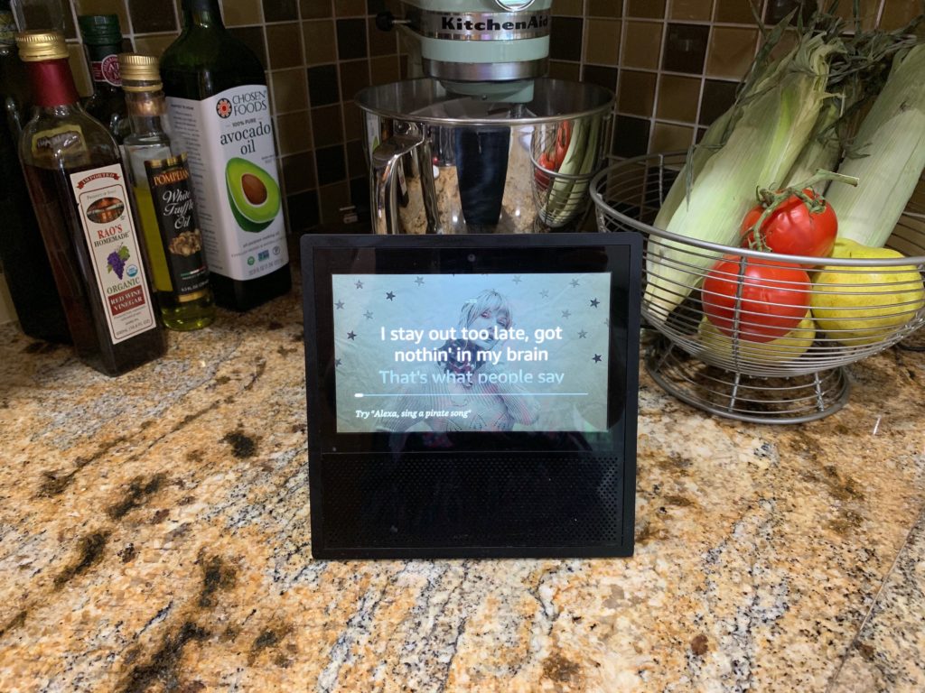 An Echo Show playing a Taylor Swift song and showing the lyrics