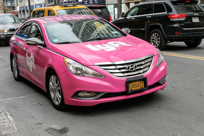 A Lyft car driving along the street