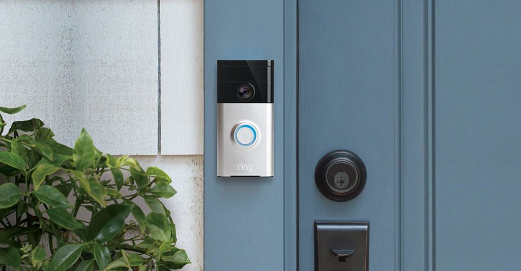 A Ring Smart Video Doorbell next to a blue outside door