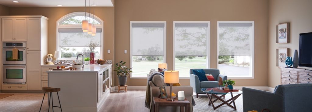 A living room with smart shades from Lutron partially drawn
